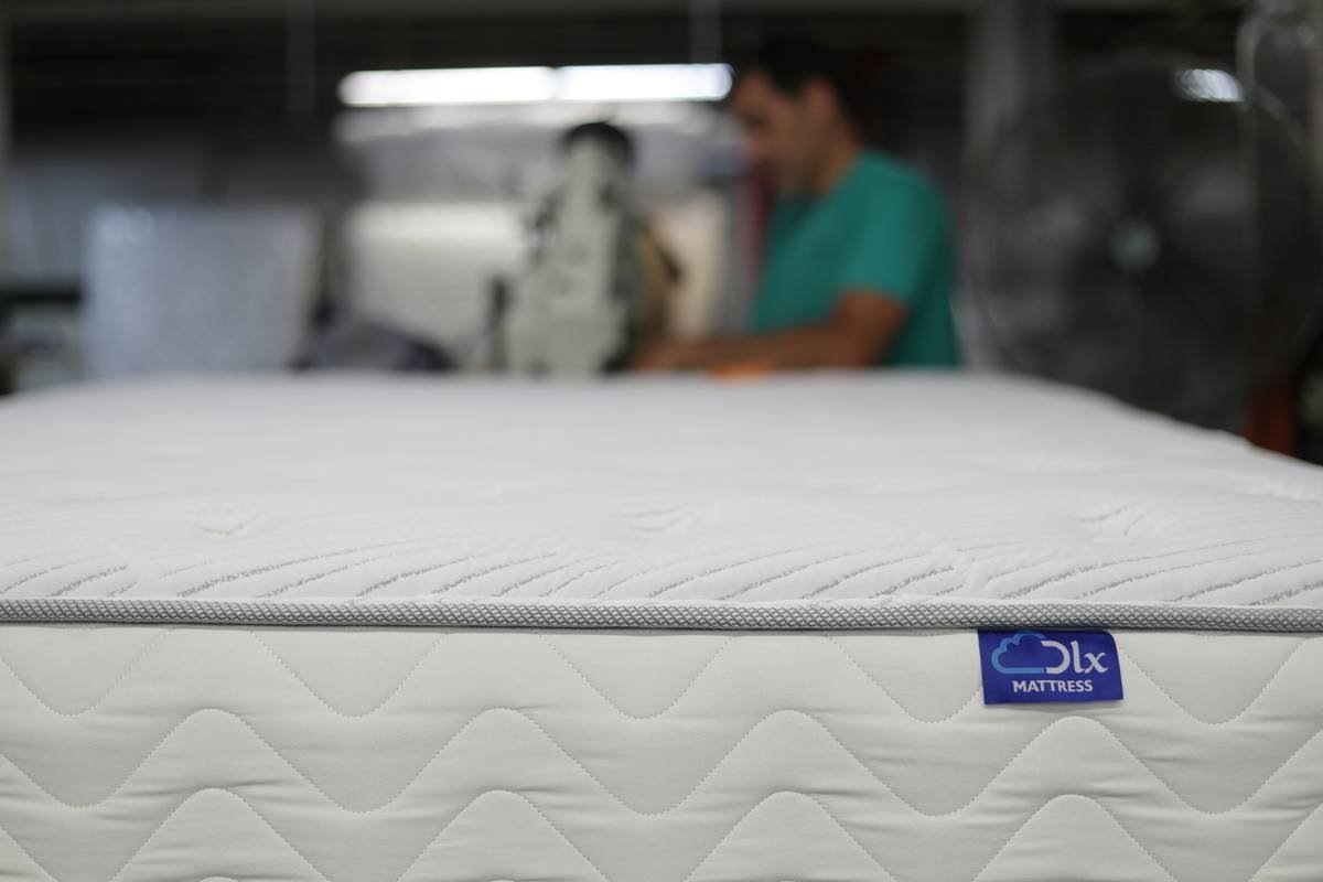 Woman sleeping peacefully on quality mattress with smart tracker showing deep sleep metrics