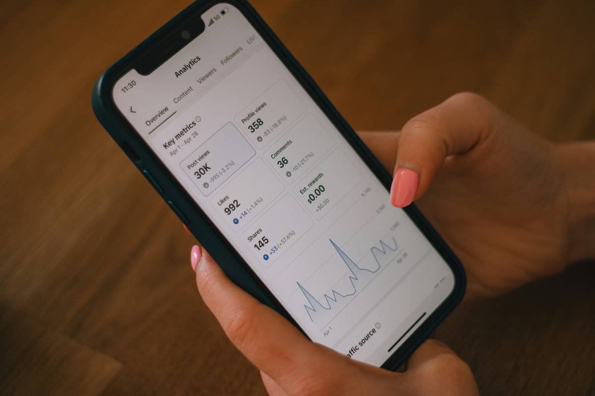 Person reviewing Sleep Monitoring Tools dashboard on tablet next to hybrid mattress